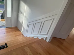 Stair landing with custom trim work in Full-Home Finish