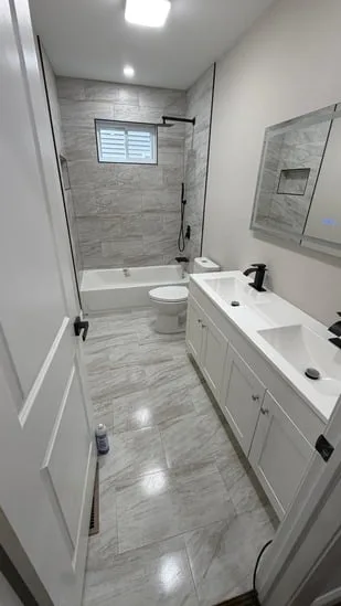 Modern bathroom remodel with dual vanity and tub shower combo