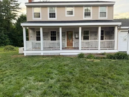 Full exterior front view of the completed front porch construction on a two-story residential home.